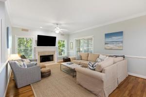 a living room with a couch and a fireplace at SM14: 14 Silver Moss in Kiawah Island