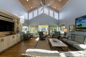 a living room with a couch and a tv at A Shore Investment in Edisto Island