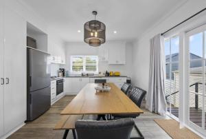 a kitchen with a wooden table and a dining room at Eureka We struck a golden home in Eureka