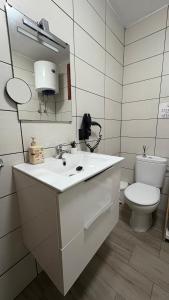 a white bathroom with a sink and a toilet at Vistas al Mar in Tacoronte +11 photos