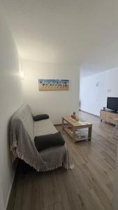 a living room with a chair and a table at Vistas al Mar in Tacoronte