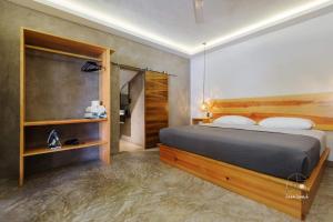 a bedroom with a bed with a wooden headboard at Unmatched And New Studio Apartment Center La Punta in Brisas de Zicatela