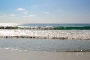 a view of the ocean with waves coming in at Unmatched And New Studio Apartment Center La Punta in Brisas de Zicatela