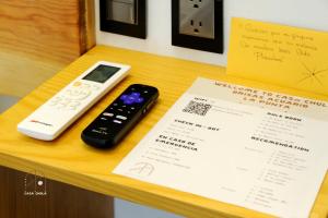 a remote control sitting on a table next to a receipt at Unmatched And New Studio Apartment Center La Punta in Brisas de Zicatela +7 photos