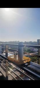 a tray with two cups on a table on a balcony at Centro Suite SDE, confort y estilo moderno en el corazón de Santiago in Santiago del Estero