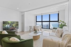 a living room with a couch and chairs and a table at Oceans Suites - Q Stay in Gold Coast