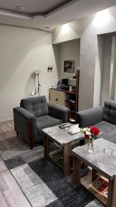 a living room with two couches and a table at A very classy and private apartment in Al Madinah
