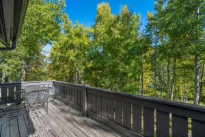 a wooden deck with a bench on it at Evergreen Escape - Home for 12 in Mid Vail +42 photos