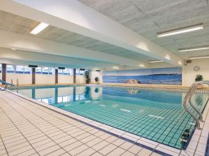 a large swimming pool with a large swimming pool at Faaborg Holiday Centre in Fåborg