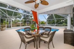 a dining room with a table and chairs at Elegant 4BR Pool Sanctuary - Ideal for Work or Play! in Palm Bay