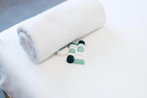 a white bed with two dolls under a towel at Strathfield Hotel in Sydney +54 photos