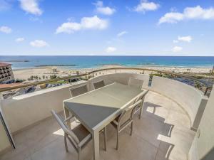 a table and chairs on a balcony with a view of the beach at Blue Horizon Penthouse in Herzliya B