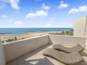 a bench on a balcony with a view of the beach at Blue Horizon Penthouse in Herzliya B