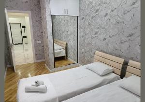 a bedroom with two beds and a mirror at Apartment baku in Baku