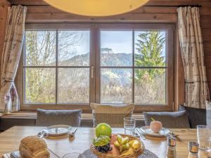 a dining room with a table and a large window at Yosi im Brixental in Wörgler Boden +46 photos