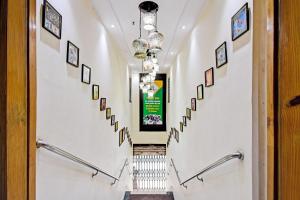 a hallway with stairs with pictures on the wall at Super Collection O Motisarai in Kolkata