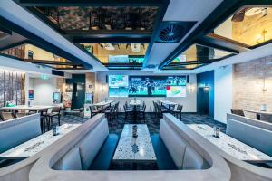 a restaurant with couches and tables and a bar at Strathfield Hotel in Sydney