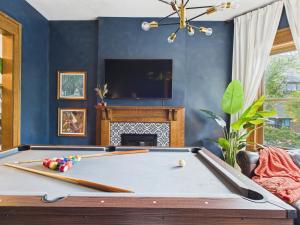 a living room with a pool table and a tv at Playoff Stay Wrigley 4br Garage Firepit Patio in Chicago