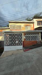 an old house with white gates on the front of it at Charming family home in San Gil! in San Gil