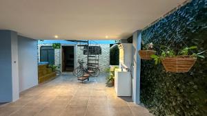 a hallway of a house with plants on the wall at Olas del alba in Tapantí