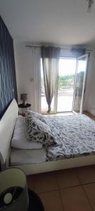 a bedroom with a bed with a large window at Kaz a Felicia-Villa avec piscine privée et vue mer in Petit-Bourg