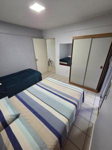 a bedroom with a bed and a mirror in it at Apto Completo Ar e Wi-Fi Parque Itaimbe in Santa Maria