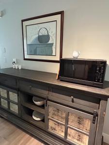 a microwave oven sitting on top of a wooden cabinet at Tandem Lodge - Unit 2 in Hendersonville