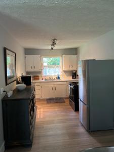 a kitchen with white cabinets and a stainless steel refrigerator at Tandem Lodge - Unit 2 in Hendersonville