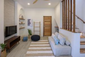 a living room with a couch and a television at New Luxury 4BR Villa with Seaview in Haad Chao Phao +5 photos