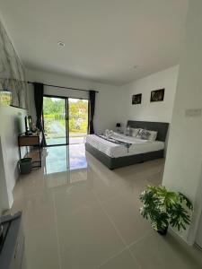 a bedroom with a bed in the middle of a room at Da Airport Hotel in Nai Yang Beach