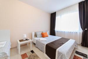 Postel nebo postele na pokoji v ubytování Sandanski Peak Guest Rooms