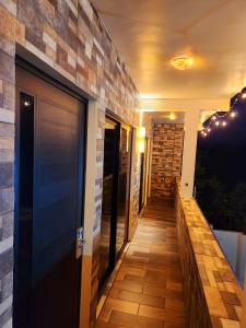 a hallway with a door and a brick wall at Villas Mar Arena in Isla Aguada
