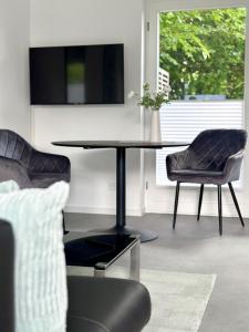 ein Wohnzimmer mit einem Tisch und zwei Stühlen in der Unterkunft Heide Apartment Heimat in Schneverdingen