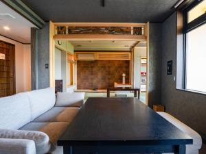 a living room with a couch and a table at Hotel WAMARE Onikobe in Hara +76 photos