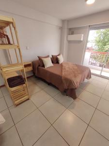 a bedroom with a bed and a ladder in it at Monoambiente Montevideo in Rosario +9 photos