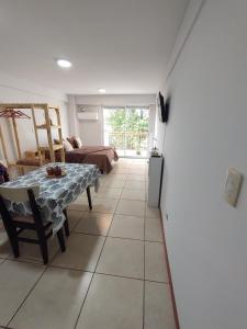 a living room with a table and a couch at Monoambiente Montevideo in Rosario