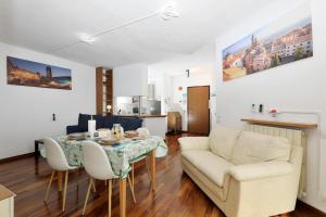 a living room with a table and a couch at Luxury Panoramic Apt w Garage Happy Home Bergamo 2 in Bergamo