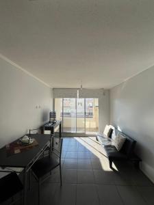 a living room with a couch and a table at Departamento equipado 203 Ovalle in Ovalle