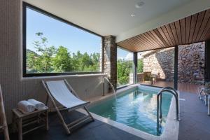 a swimming pool with a chair and a hammock in a house at Bonansa Country Hotel in Bonansa
