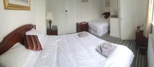 a bedroom with two beds with white sheets at Ingram Arms, HATFIELD in Doncaster