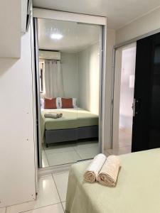 a reflection of a bedroom with a bed in a mirror at Apartment in Ananindeua in Ananindeua