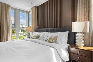 a bedroom with a white bed and a large window at Isla Verde 3BR Condo 3Min To Beach 5Min To Airport - Solemare I in San Juan +54 photos