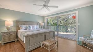 a bedroom with a bed and a sliding glass door at Hemingway House - 117 in Siesta Key +52 photos