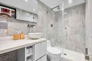 a bathroom with a toilet and a sink and a shower at Old San Juan Art Loft Fast Wifi Near El Morro in San Juan +15 photos