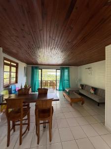 a living room with a table and a couch at Luna's Home Raiatea  +29 photos