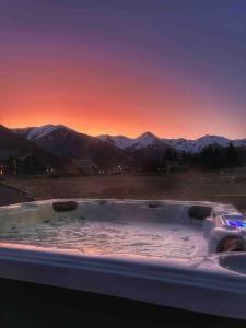 a hot tub with a view of the mountains at Hot Tub and Views in Castle Hill