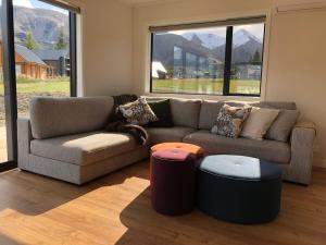a living room with a couch and two stools at Hot Tub and Views in Castle Hill