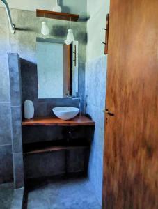 a bathroom with a sink and a mirror at Terrazas del Pinar, Loft en bosque serrano in Villa Ciudad de America