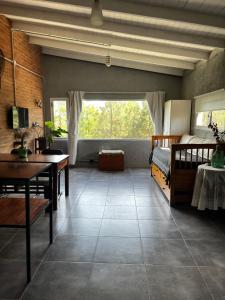 a bedroom with a bed and a table and a window at Terrazas del Pinar, Loft en bosque serrano in Villa Ciudad de America +24 photos