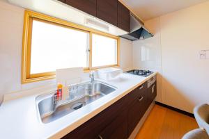 a kitchen with a sink and a window at Extreme in Sapporo